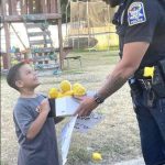 Police officer surprises 7-year-old boy selling lemonade with a pair of brand new sneakers for school